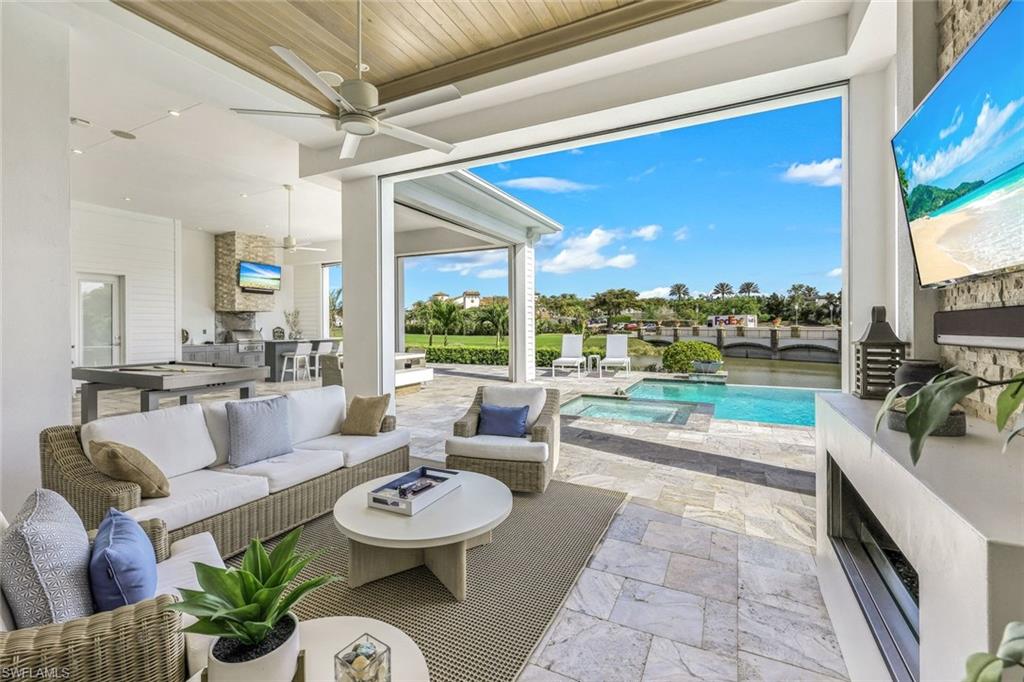 16415 Seneca Way Naples, FL 34110 - Photo 37 of 50 a living room with furniture and a floor to ceiling window