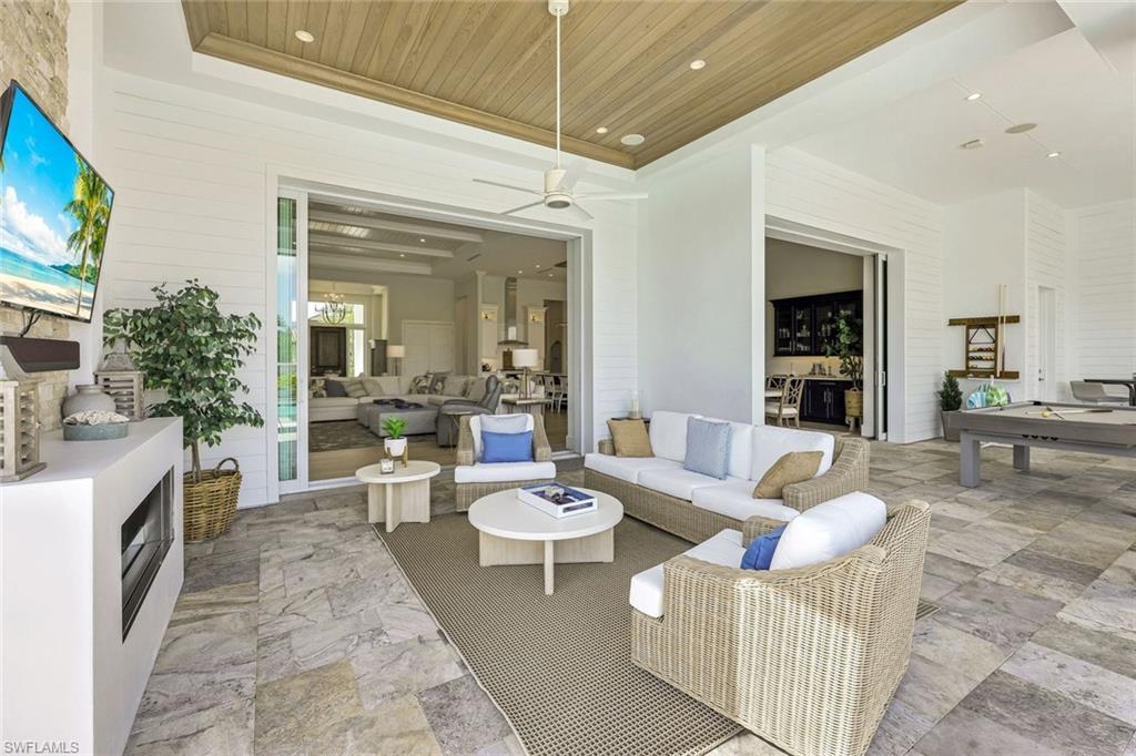 16415 Seneca Way Naples, FL 34110 - Photo 38 of 50 a living room with furniture and a fireplace