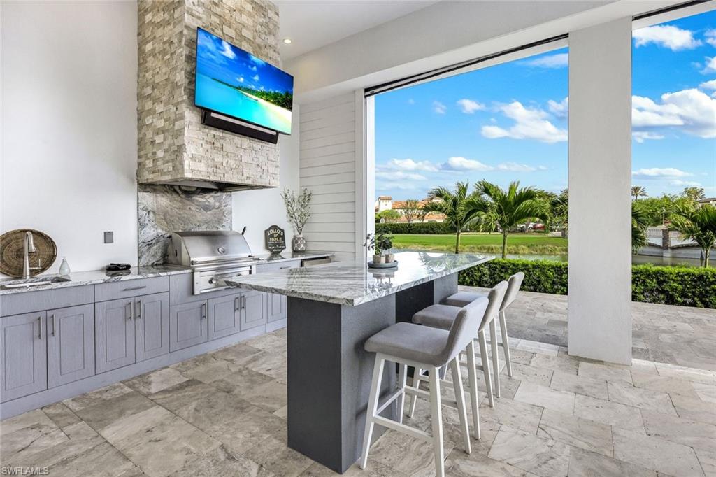 16415 Seneca Way Naples, FL 34110 - Photo 41 of 50 a view of a kitchen with granite countertop a table and chairs in it