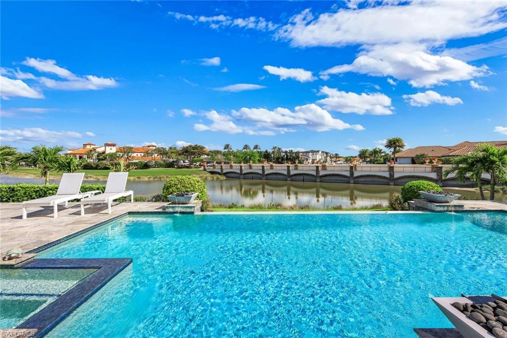 16415 Seneca Way Naples, FL 34110 - Photo 43 of 50 a view of a lake with houses in the back