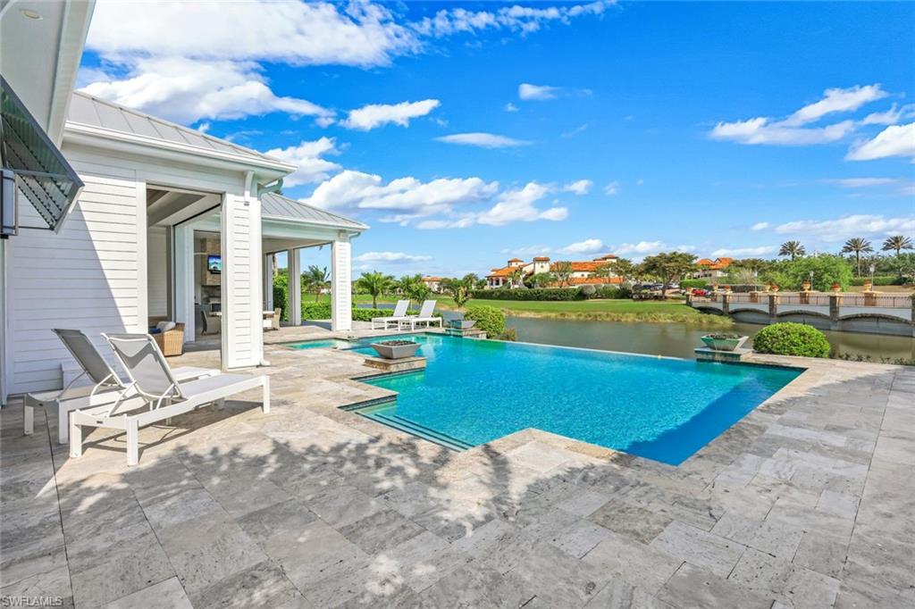 16415 Seneca Way Naples, FL 34110 - Photo 45 of 50 a view of a swimming pool and lounge chairs