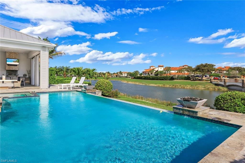 16415 Seneca Way Naples, FL 34110 - Photo 46 of 50 a view of a lake with houses in the back