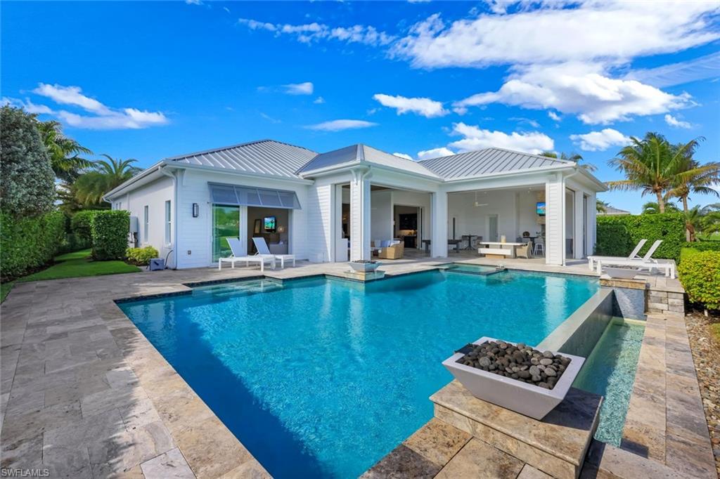 16415 Seneca Way Naples, FL 34110 - Photo 47 of 50 a view of a patio with couches table and chairs with wooden floor and fence