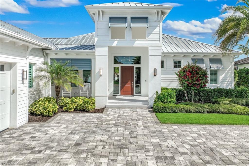 16415 Seneca Way Naples, FL 34110 - Photo 6 of 50 a front view of a house with garden
