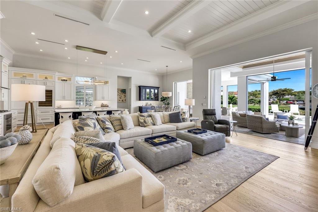16415 Seneca Way Naples, FL 34110 - Photo 10 of 50 a living room with furniture wooden floor and a large window