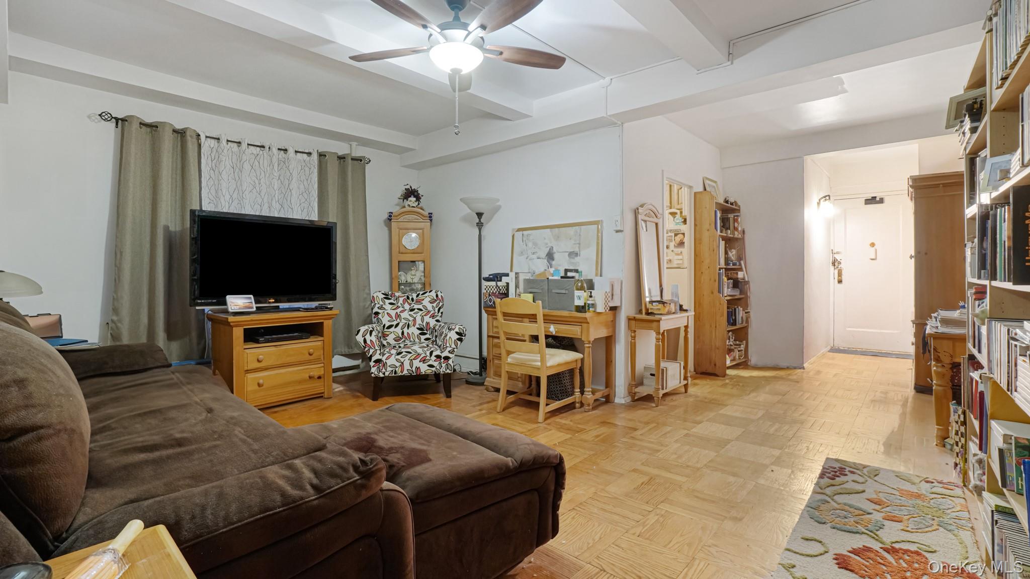 2075 St Raymond Avenue, Unit 5H Bronx, NY 10462 - Photo 4 of 8 a living room with furniture and a flat screen tv
