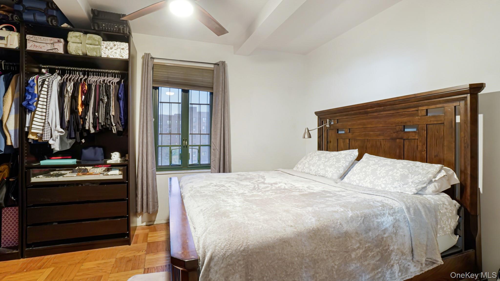 2075 St Raymond Avenue, Unit 5H Bronx, NY 10462 - Photo 5 of 8 a bedroom with a bed and lamp