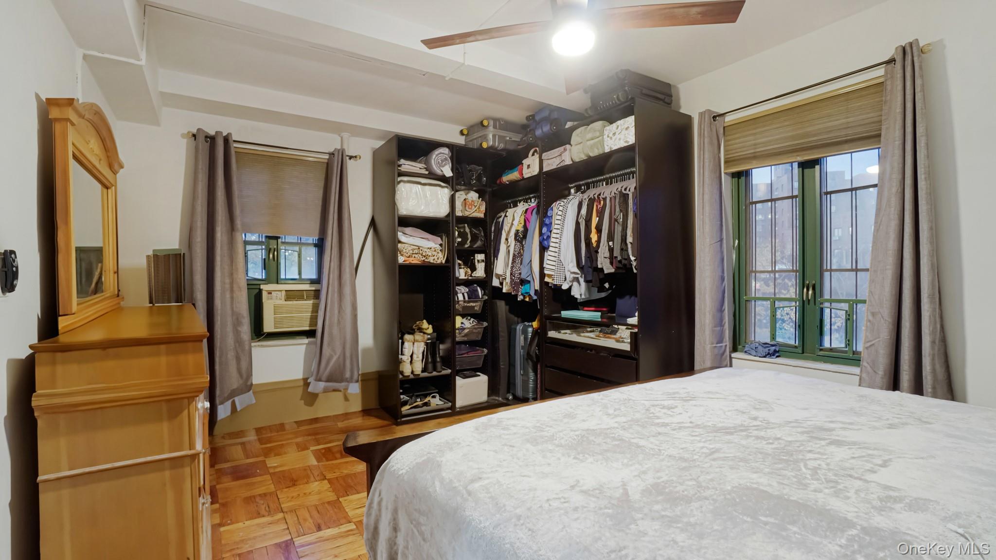 2075 St Raymond Avenue, Unit 5H Bronx, NY 10462 - Photo 6 of 8 a bedroom with a bed and a large mirror