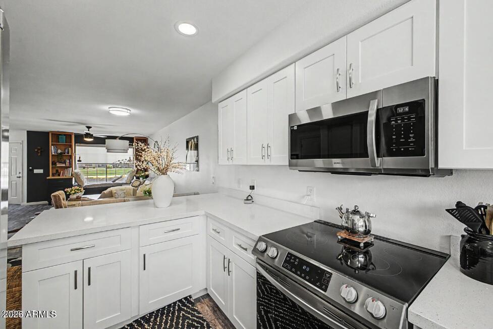860 North McQueen Road, Unit 1135 Chandler, AZ 85225 - Photo 11 of 24 a kitchen with a sink stainless steel appliances and cabinets