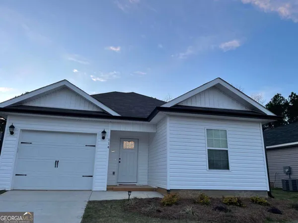 a front view of a house with yard