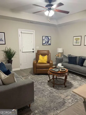 a living room with furniture and a potted plant