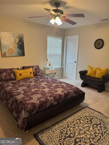 a bedroom with a bed and window