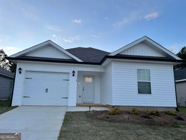 a front view of a house with garage