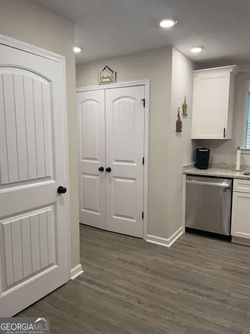 a view of a kitchen with wooden cabinet