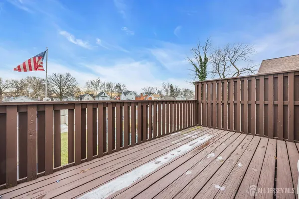a balcony with wooden floor and fence