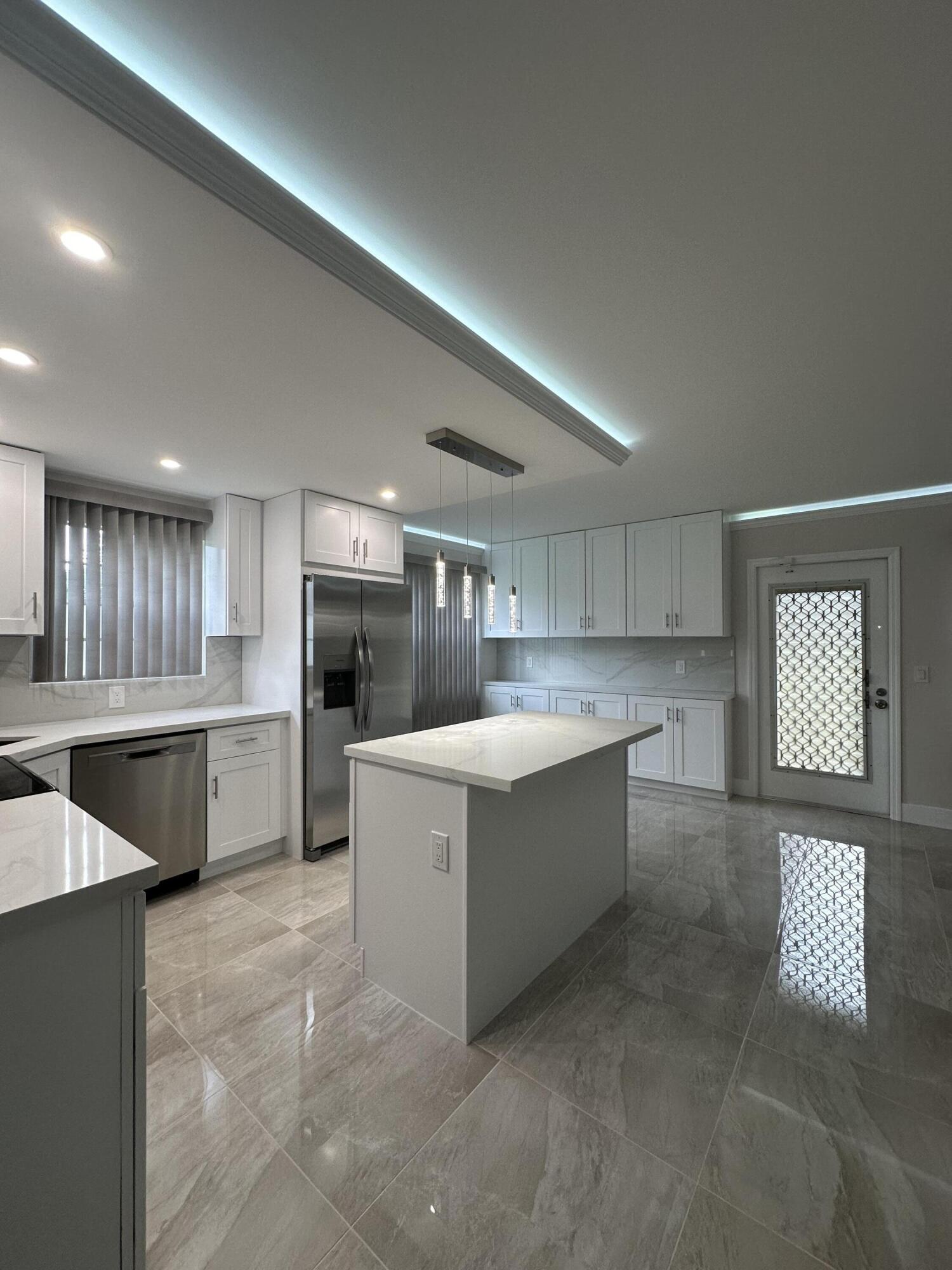 256 Suffolk F Boca Raton, FL 33434 - Photo 14 of 24 a large kitchen with a large counter top appliances and cabinets