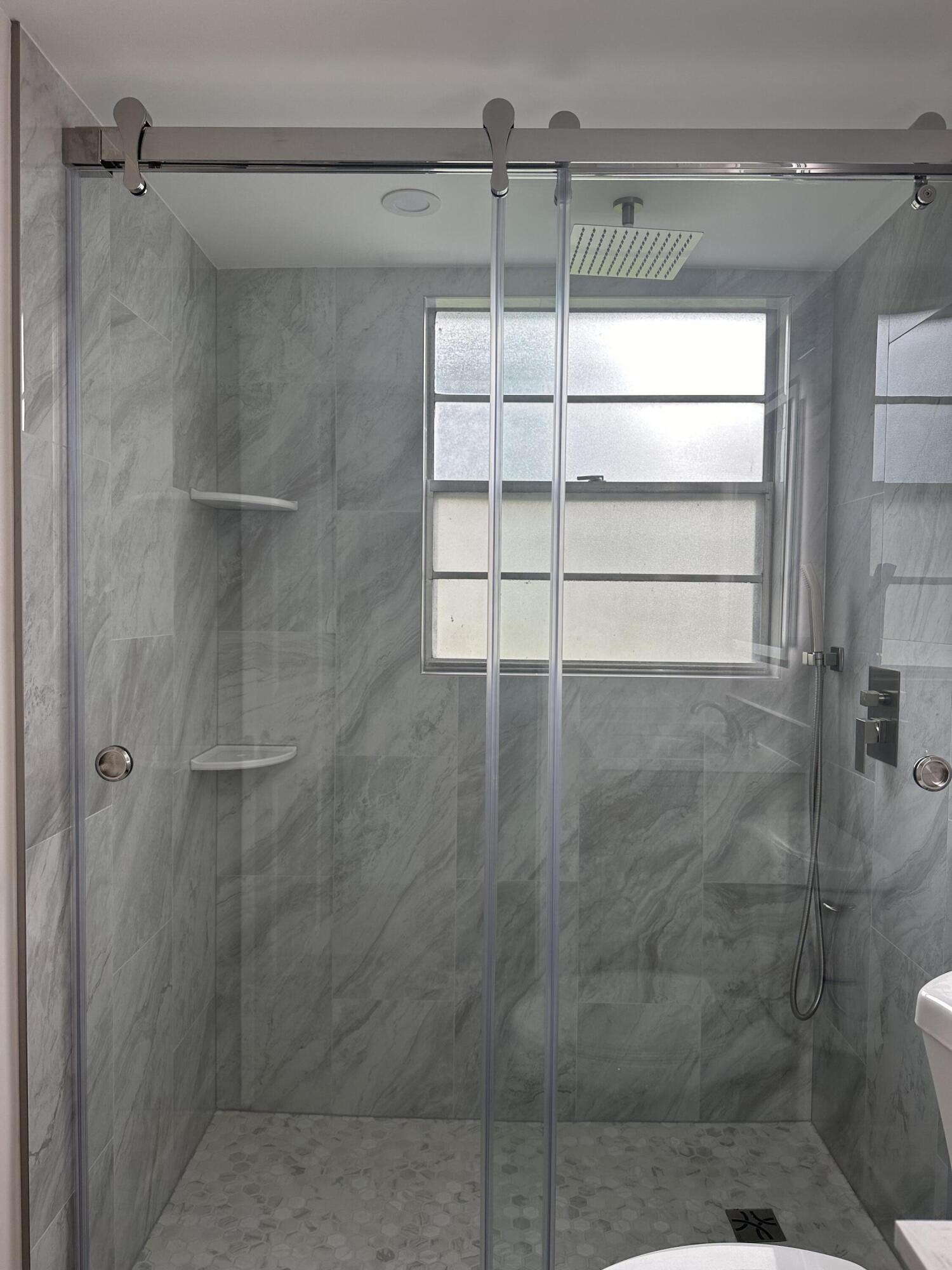 256 Suffolk F Boca Raton, FL 33434 - Photo 6 of 24 a bathroom with a shower