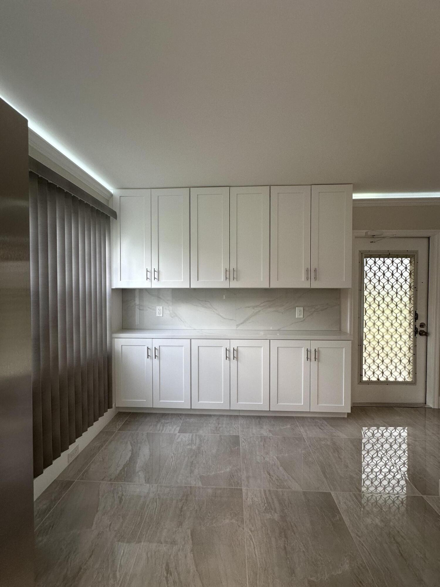 256 Suffolk F Boca Raton, FL 33434 - Photo 7 of 24 a view of an empty room with a window