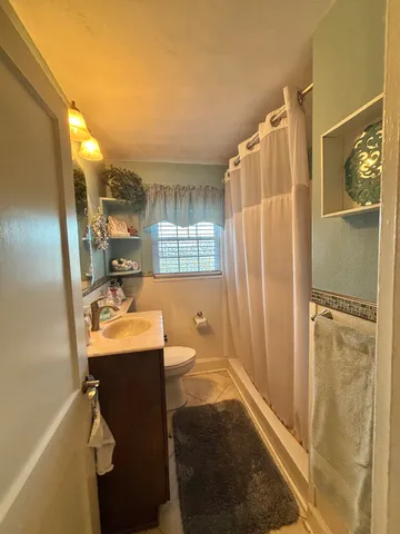 a living room with a bed furniture and a flat screen tv