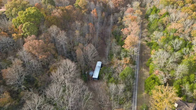 a view of a houses with a lush green forest