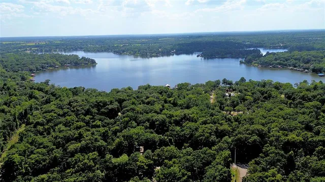 an aerial view of a houses with a lake view