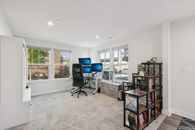 a view of a workspace with furniture and a window