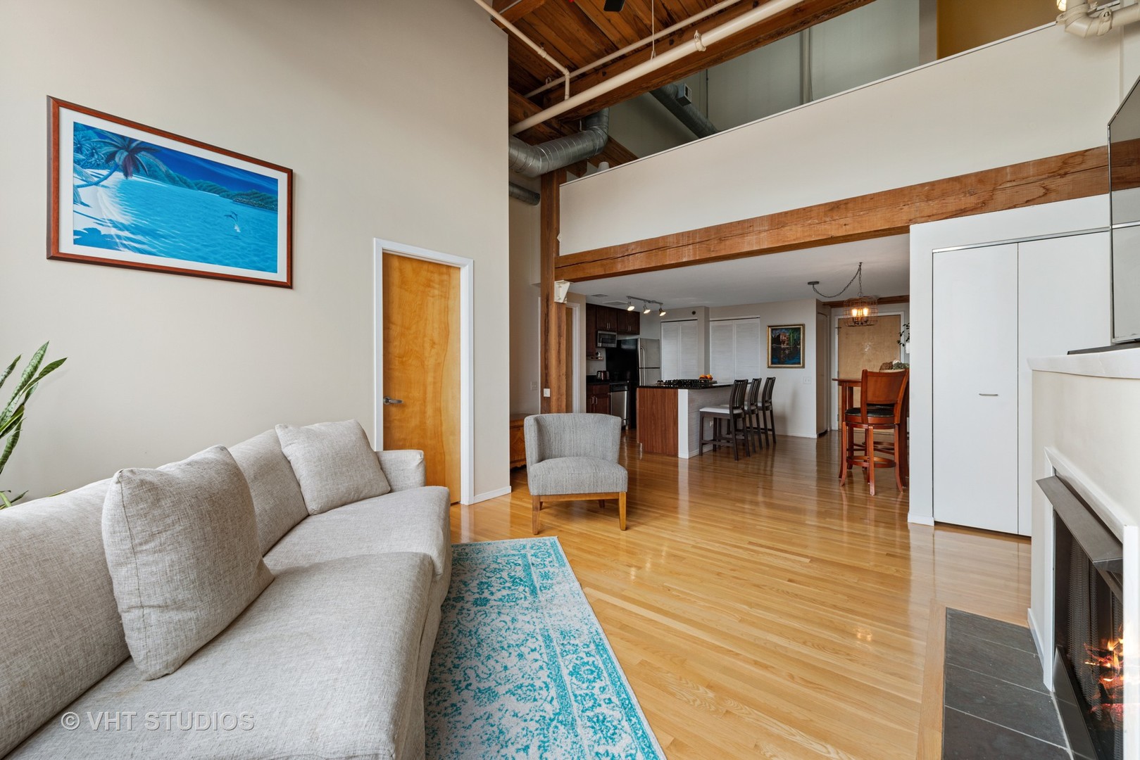 1727 South Indiana Avenue, Unit 409 Chicago, IL 60616 - Photo 7 of 21 a living room with furniture and a dining table with wooden floor