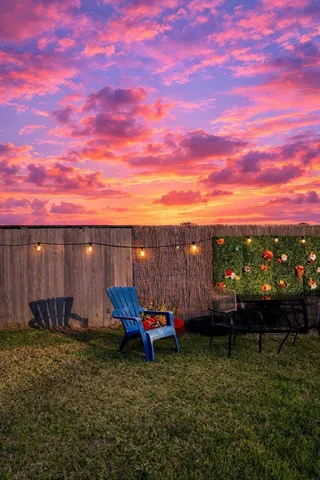 a view of a backyard with sitting area