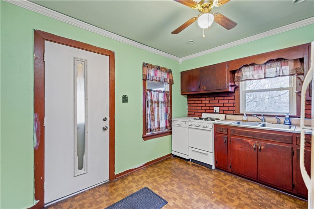 3910 Shepard Road Gibsonia, PA 15044 - Photo 3 of 25 a kitchen with a stove a sink and cabinets