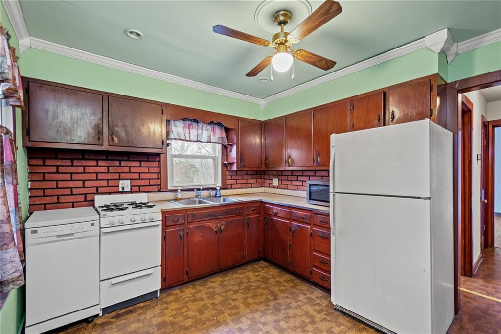 3910 Shepard Road Gibsonia, PA 15044 - Photo 4 of 25 a kitchen with a sink stainless steel appliances a refrigerator and cabinets