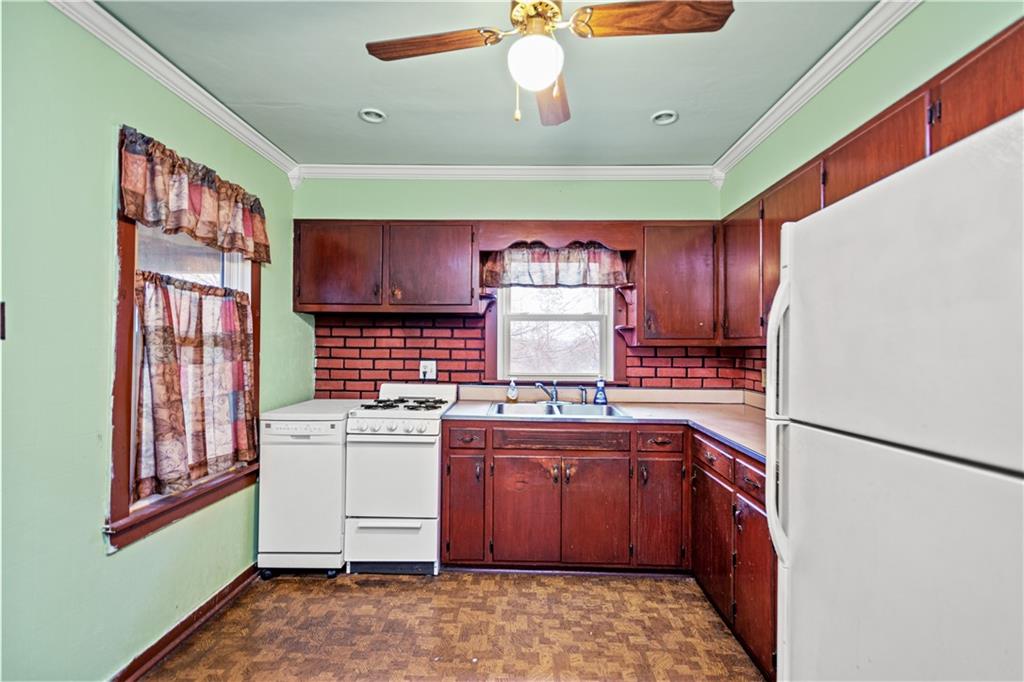 3910 Shepard Road Gibsonia, PA 15044 - Photo 5 of 25 a kitchen with a sink stove and cabinets