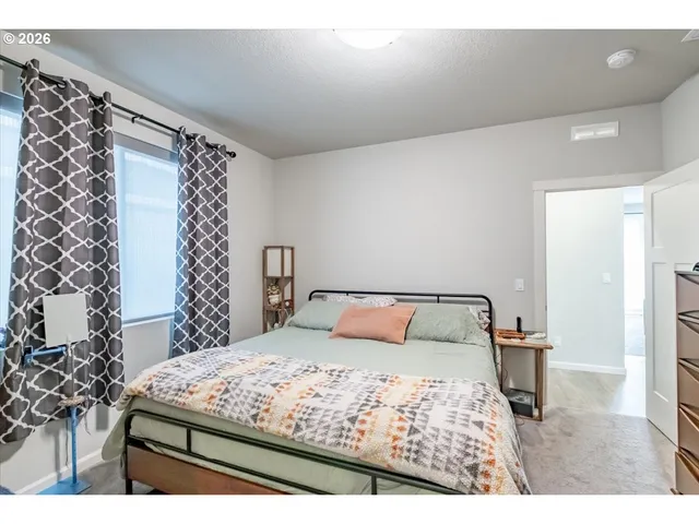 a bedroom with a bed and a view of bathroom