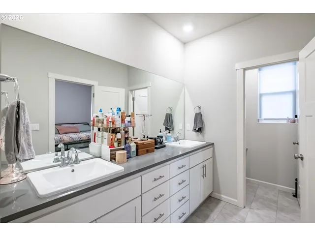 a bathroom with a sink double vanity and mirror