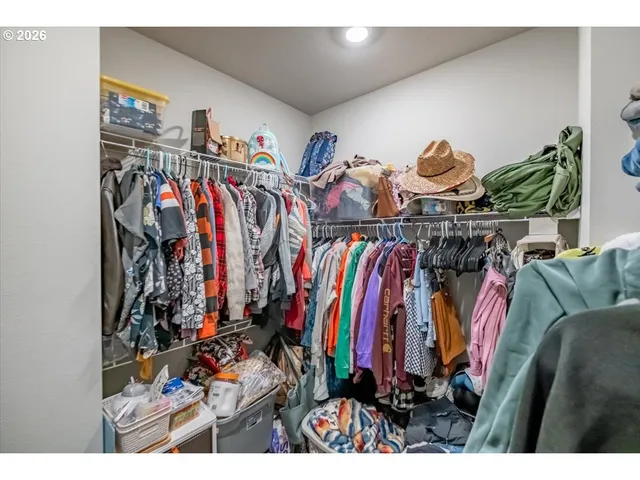 a view of walk in closet with clothes