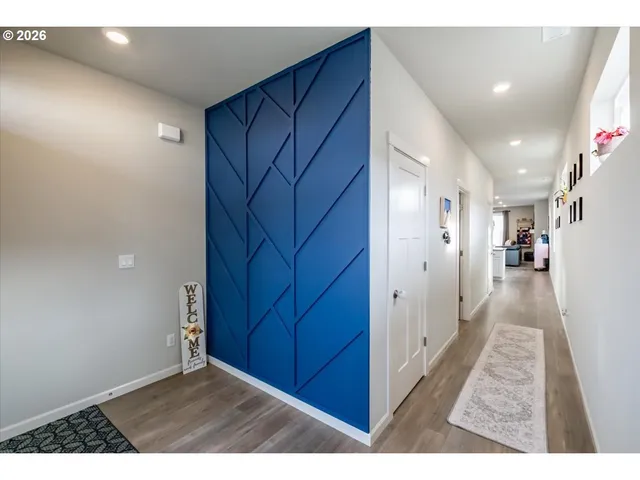 a view of a hallway with wooden floor