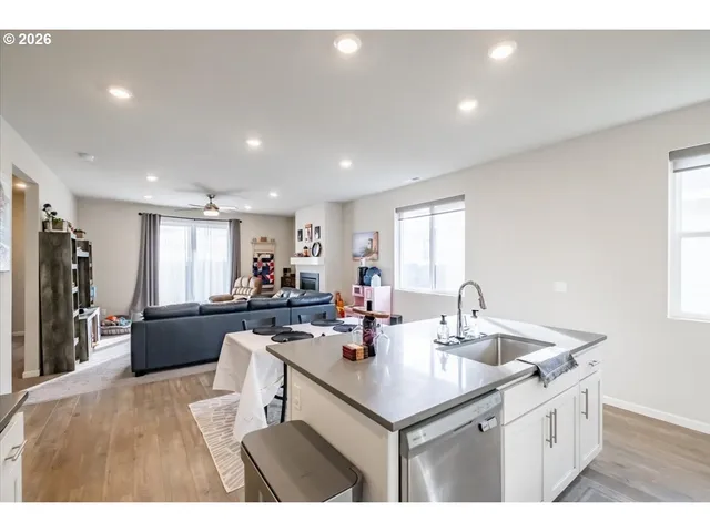 a kitchen with a sink and white cabinets