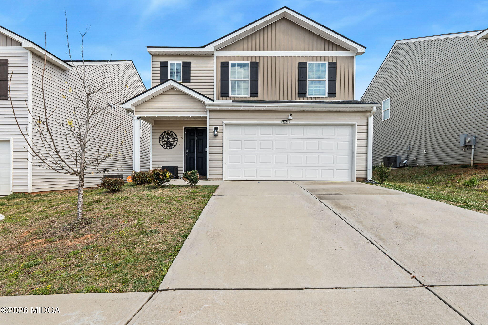 a front view of a house with a yard and garage