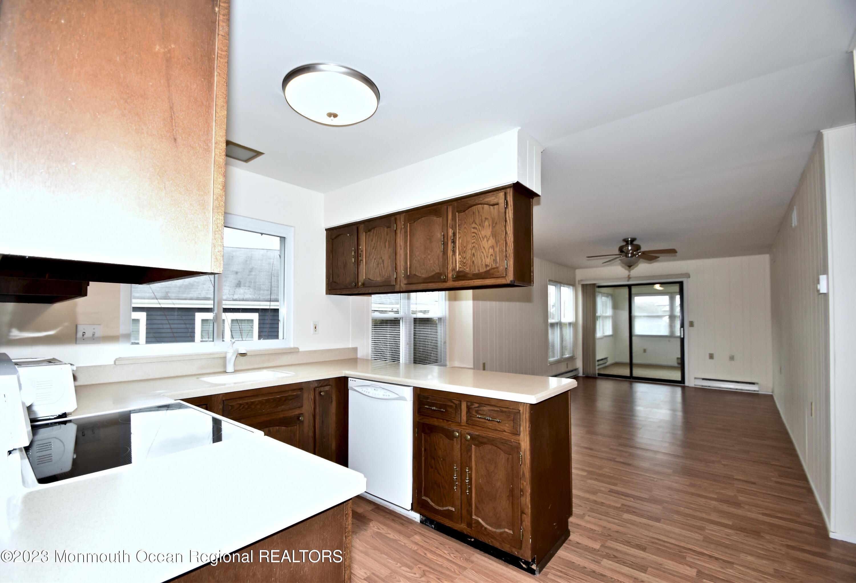 7 Flintshire Terrace Manchester Township, NJ 08759 - Photo 14 of 24 a living room with stainless steel appliances kitchen island granite countertop a sink a stove and a microwave oven