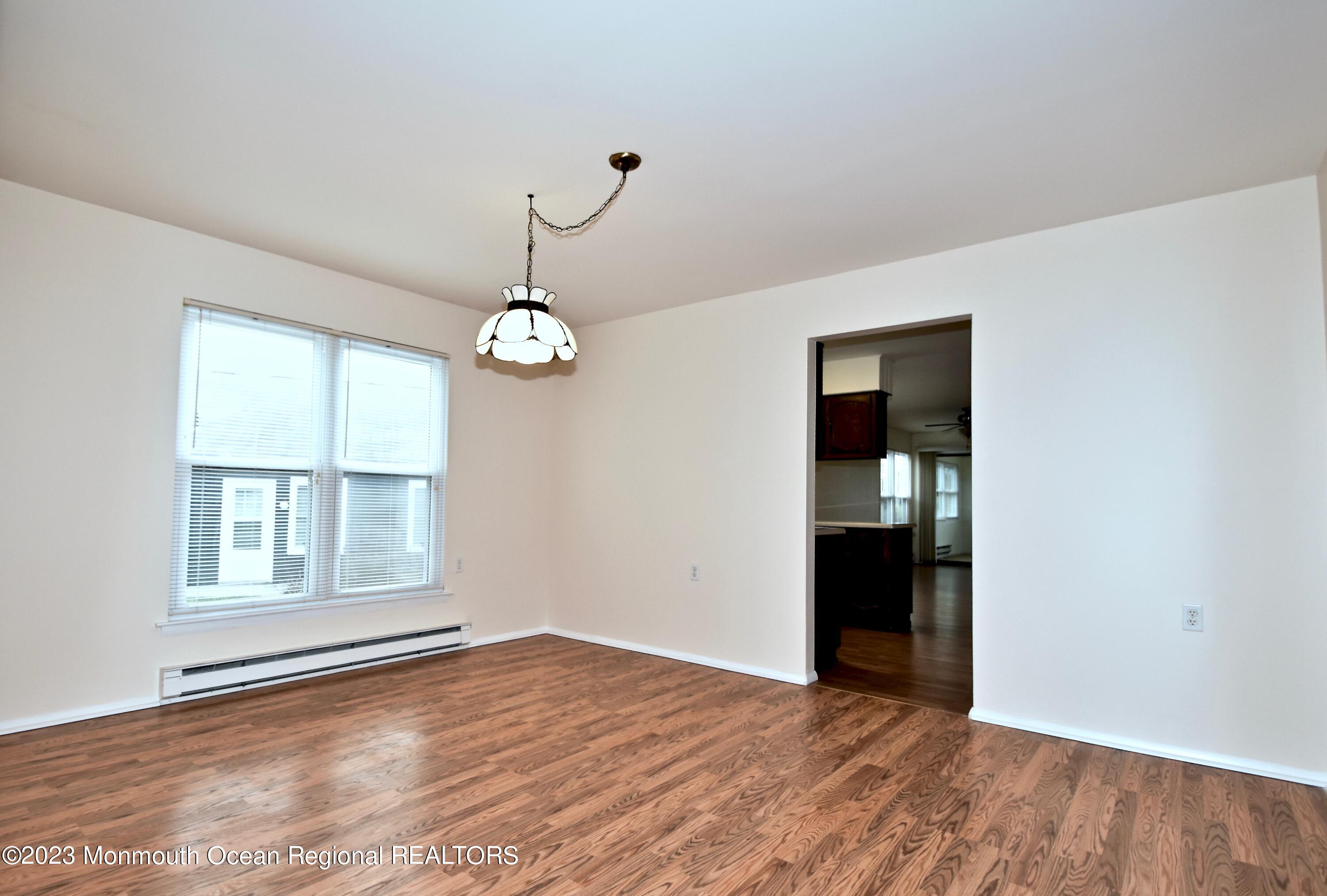 7 Flintshire Terrace Manchester Township, NJ 08759 - Photo 6 of 24 an empty room with wooden floor cabinet and windows