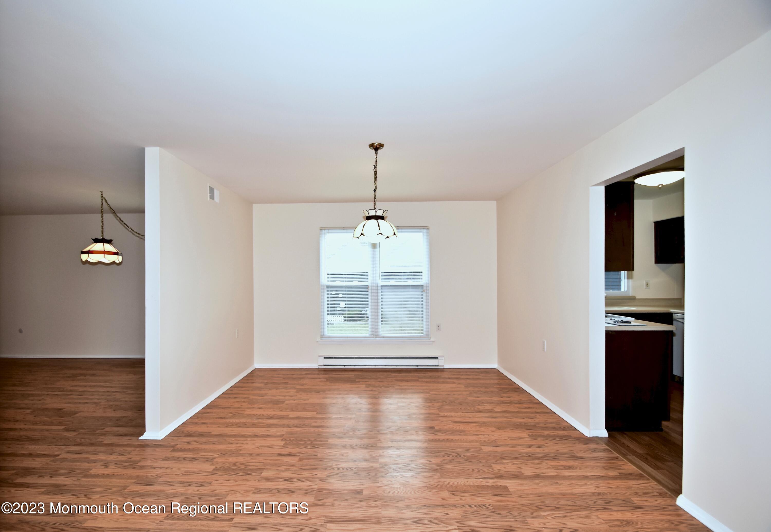 7 Flintshire Terrace Manchester Township, NJ 08759 - Photo 7 of 24 a view of an empty room with window and wooden floor