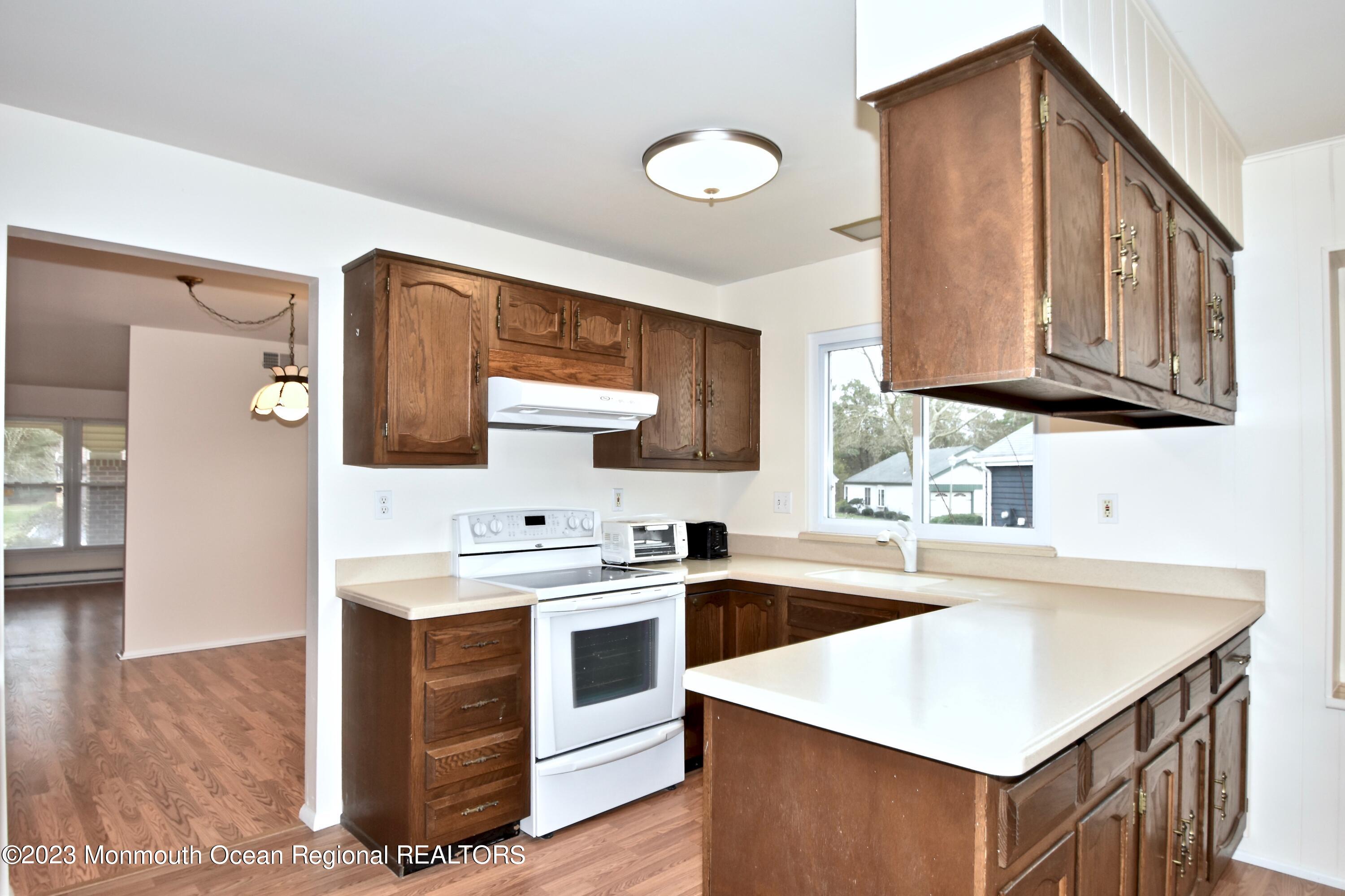 7 Flintshire Terrace Manchester Township, NJ 08759 - Photo 10 of 24 a kitchen with stainless steel appliances granite countertop a sink stove and cabinets