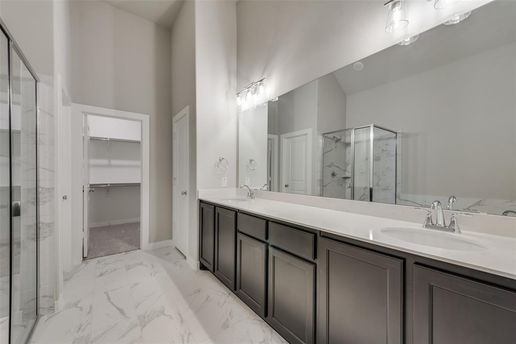 527 Embargo Drive Fate, TX 75189 - Photo 13 of 18 a bathroom with a double vanity sink and a mirror