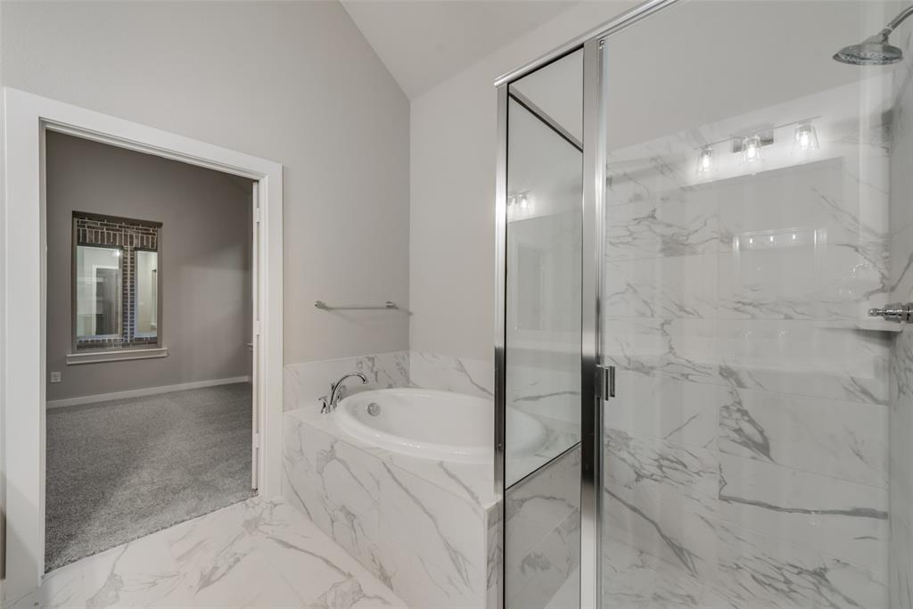 527 Embargo Drive Fate, TX 75189 - Photo 14 of 18 a bathroom with a bathtub and shower