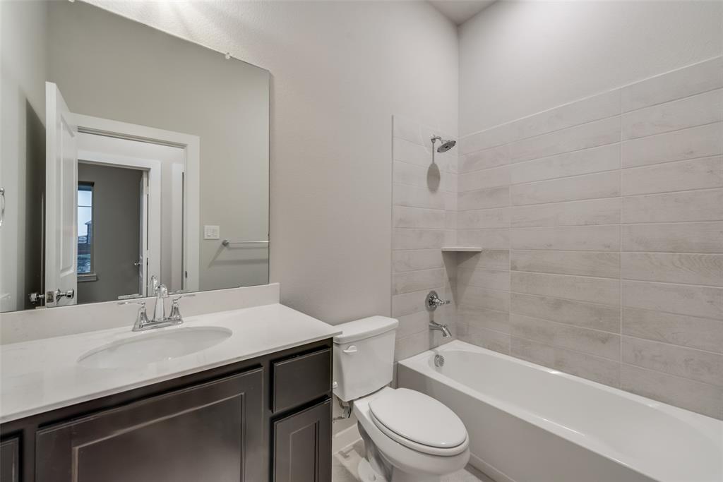 527 Embargo Drive Fate, TX 75189 - Photo 16 of 18 a bathroom with a sink a toilet and shower