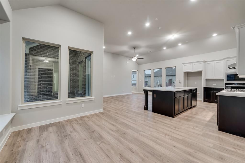 527 Embargo Drive Fate, TX 75189 - Photo 3 of 18 a view of kitchen with stainless steel appliances granite countertop a large counter top and wooden floors