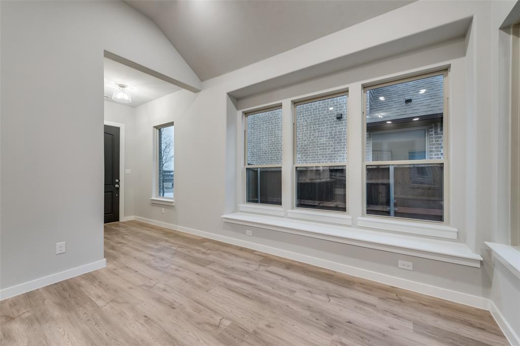 527 Embargo Drive Fate, TX 75189 - Photo 4 of 18 an empty room with wooden floor and windows