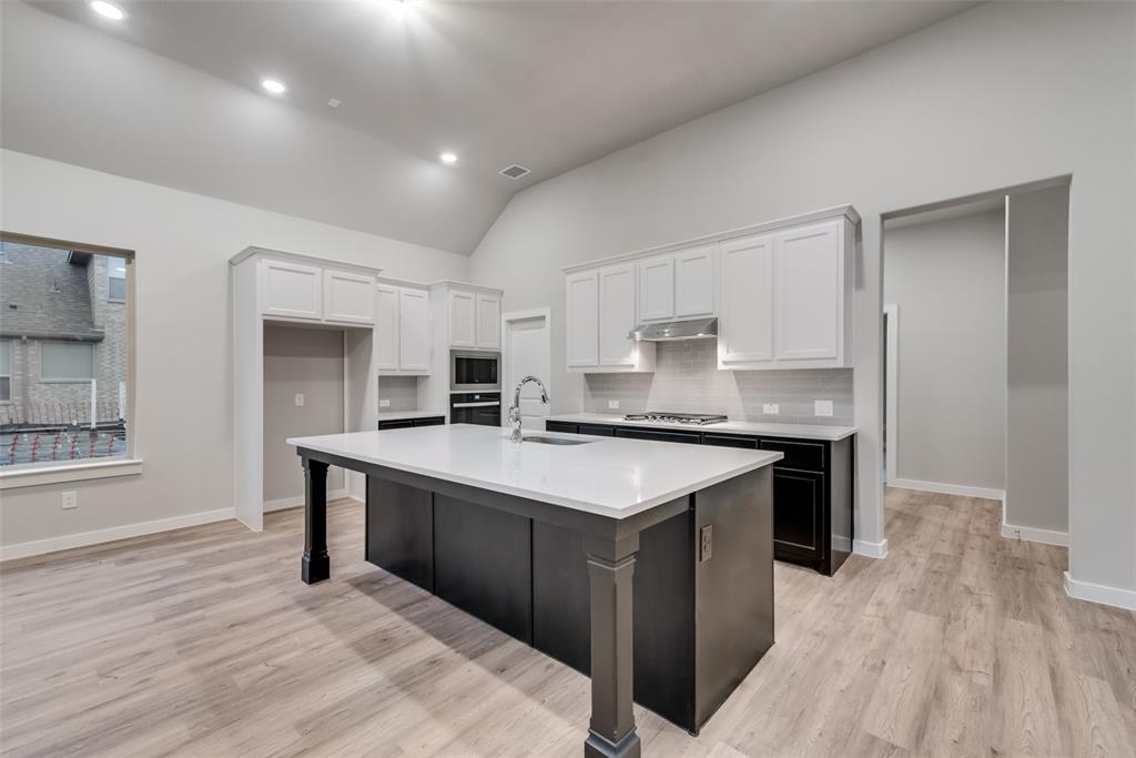 527 Embargo Drive Fate, TX 75189 - Photo 5 of 18 a kitchen with stainless steel appliances granite countertop a sink stove and refrigerator