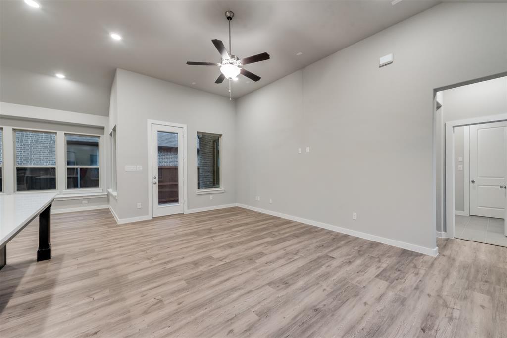 527 Embargo Drive Fate, TX 75189 - Photo 7 of 18 a view of an empty room with wooden floor and a window