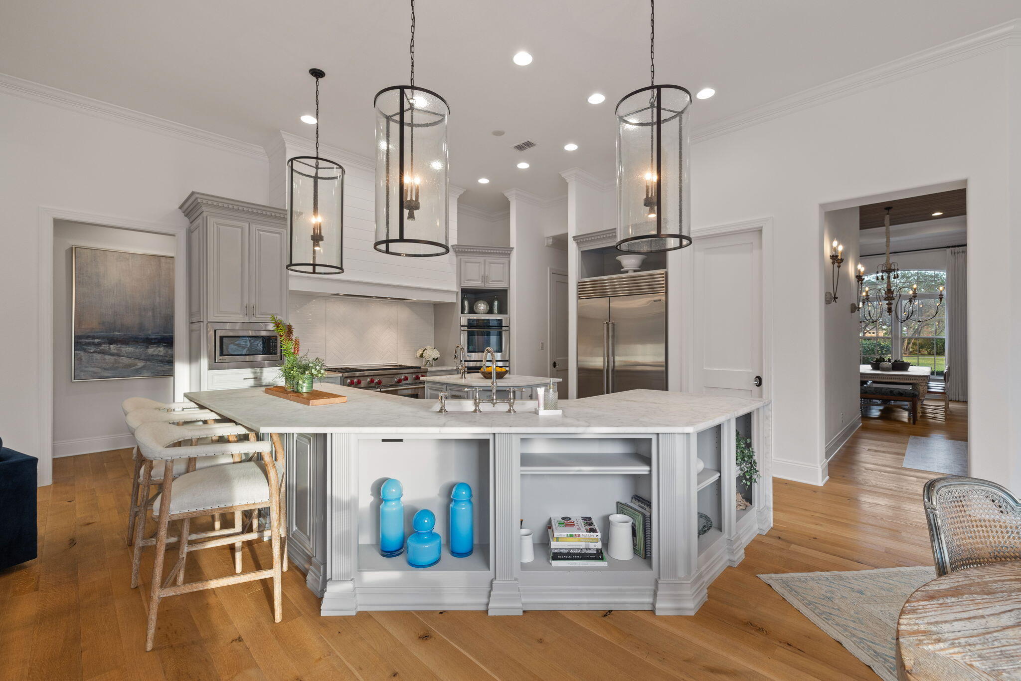 486 Coastal Breeze Drive Freeport, FL 32439 - Photo 11 of 70 a kitchen with stainless steel appliances granite countertop a stove a refrigerator a oven a sink a dining table and chairs with wooden floor