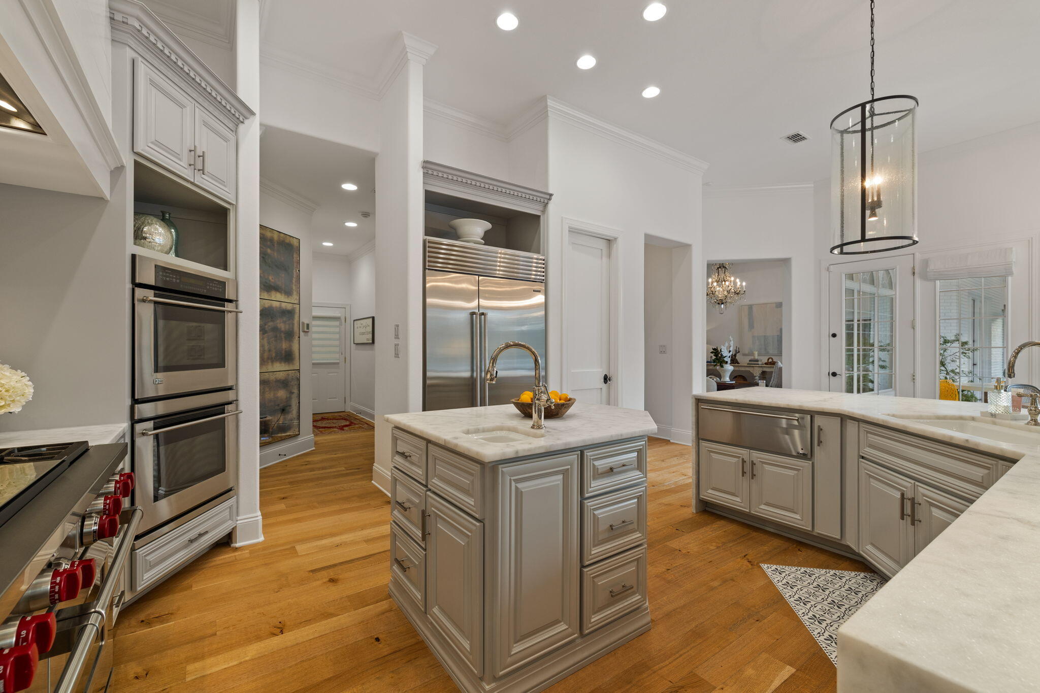 486 Coastal Breeze Drive Freeport, FL 32439 - Photo 13 of 70 a kitchen that has a lot of cabinets in it and wooden floor